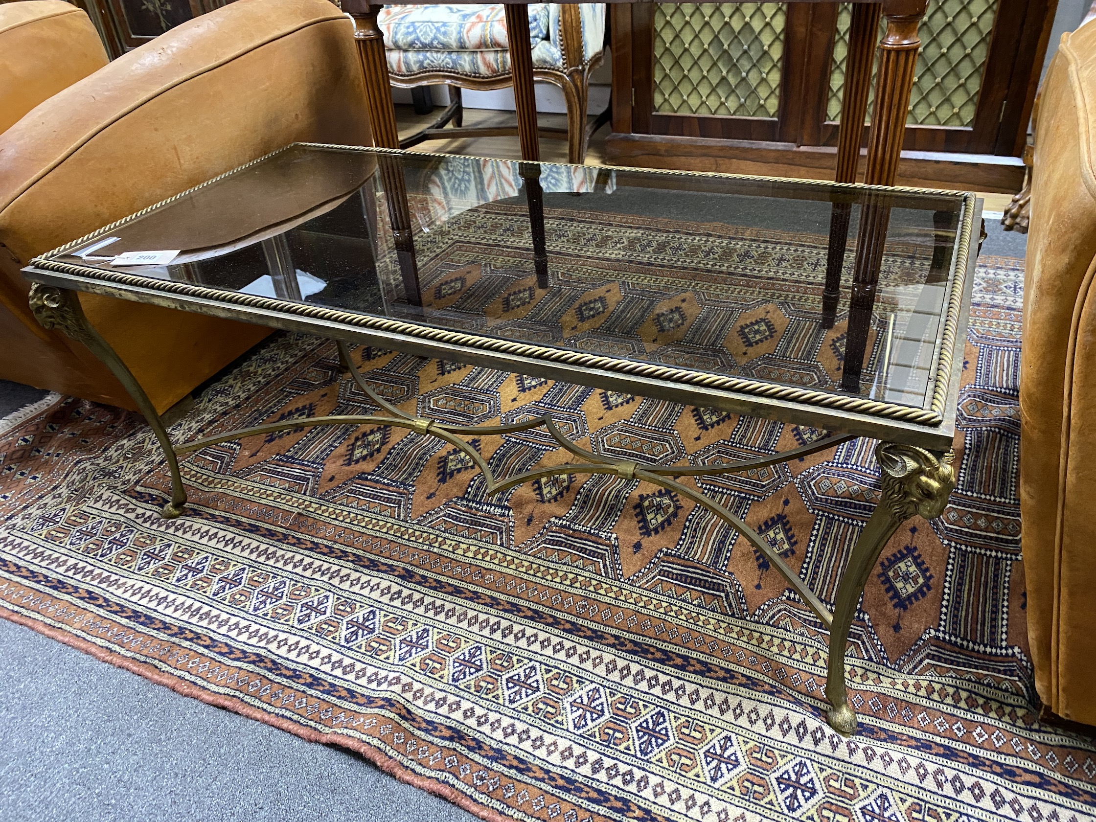 A mid century rectangular gilt metal ram's head glass top coffee table, width 104cm, depth 51cm, height 41cm